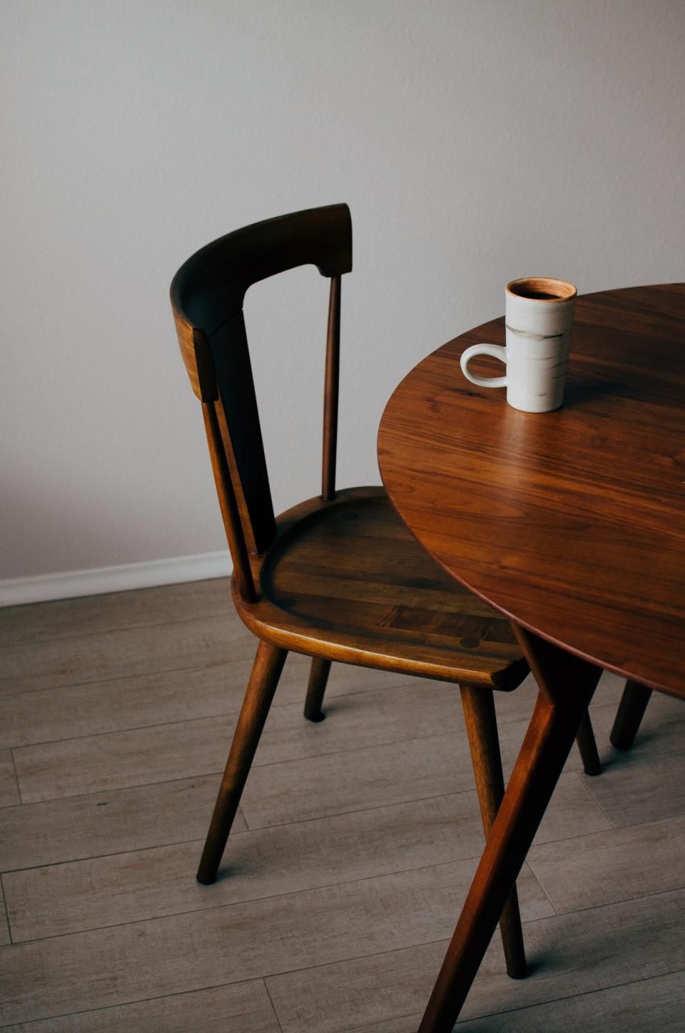 Wooden dining table with a chair in natural light